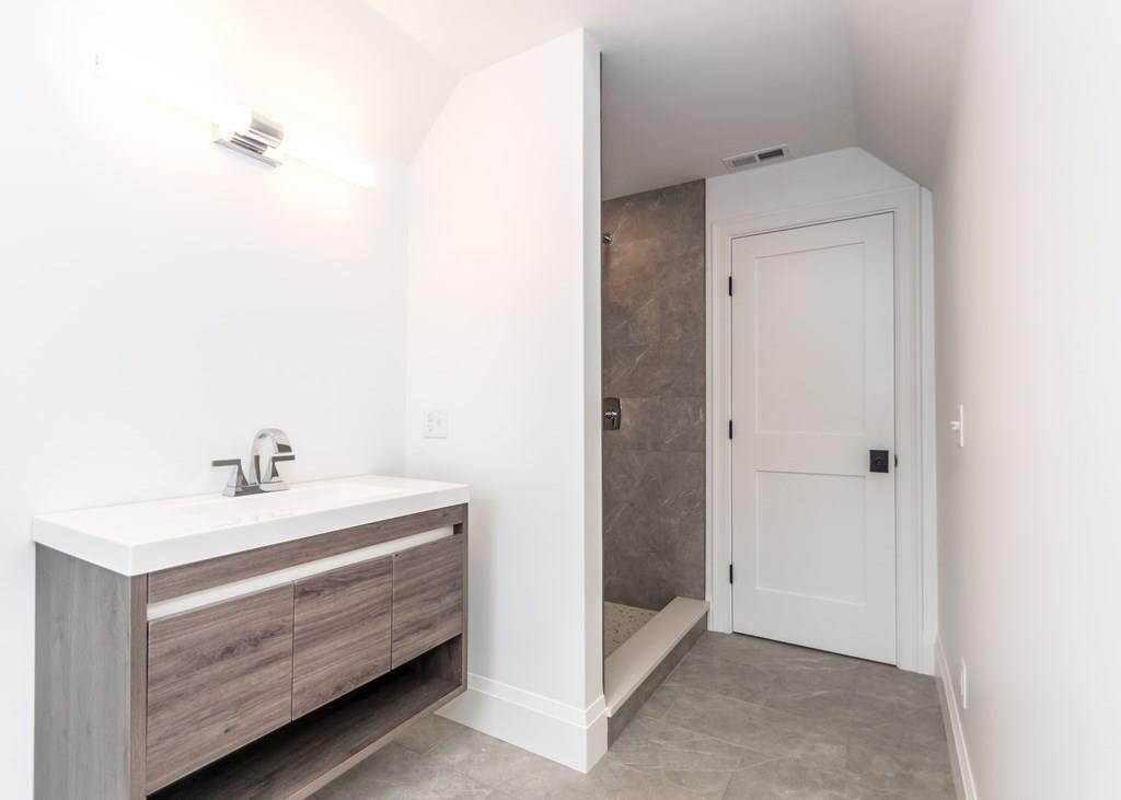 56 Pershing Road Needham, MA 02494 - Photo 35 of 42 a bathroom with a sink and a mirror