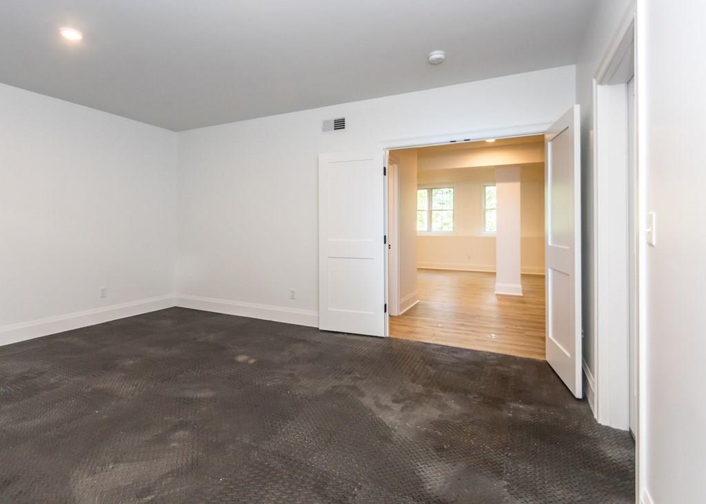 56 Pershing Road Needham, MA 02494 - Photo 36 of 42 an empty room with wooden floor and windows