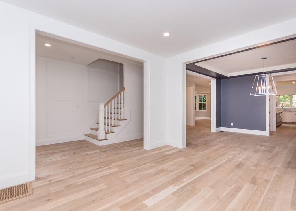 56 Pershing Road Needham, MA 02494 - Photo 4 of 42 a view of an empty room with wooden floor and stairs