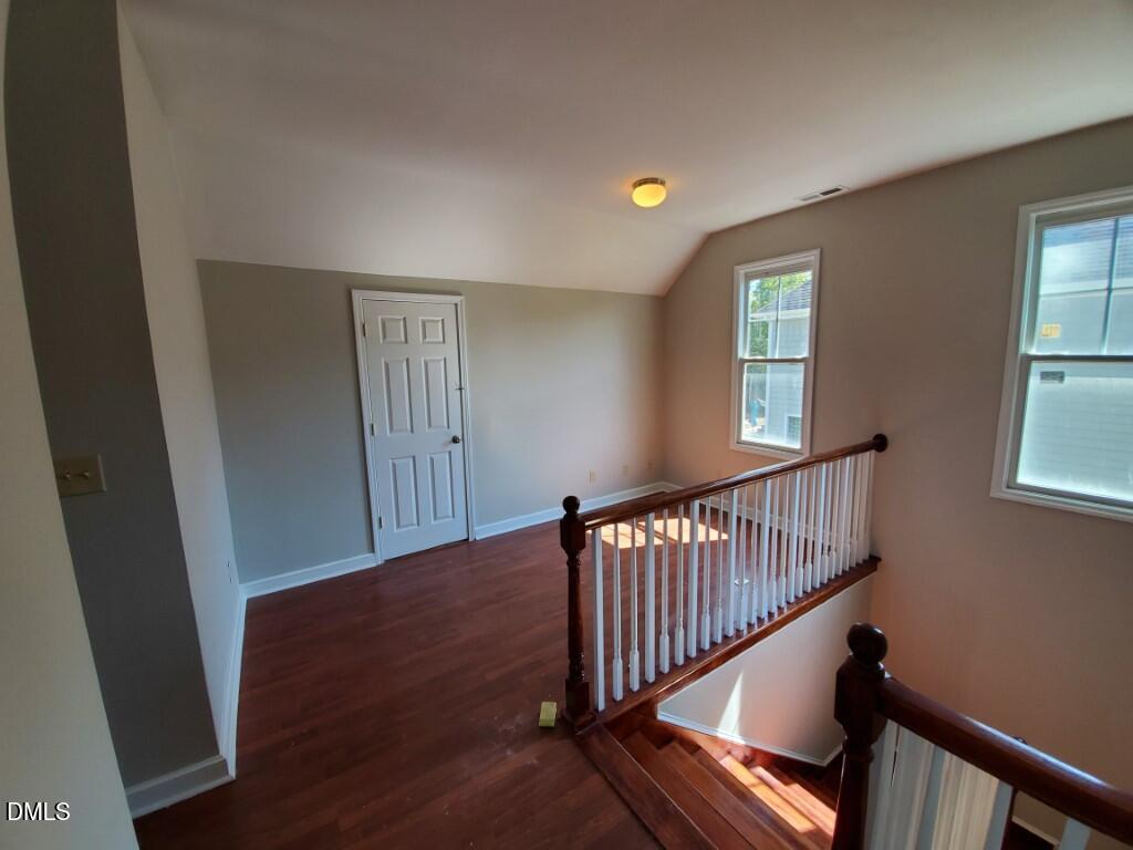 8007 Sundance Circle Durham, NC 27713 - Photo 12 of 23 a view of hallway with window and wooden floor