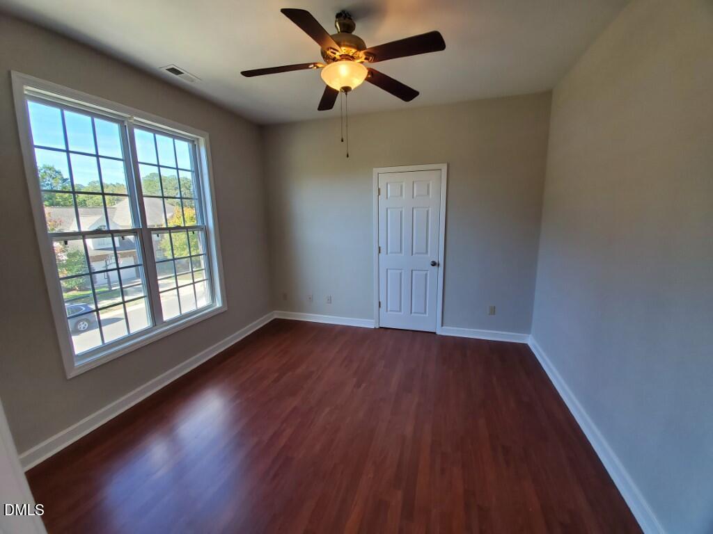 8007 Sundance Circle Durham, NC 27713 - Photo 13 of 23 a view of an empty room with window and wooden floor