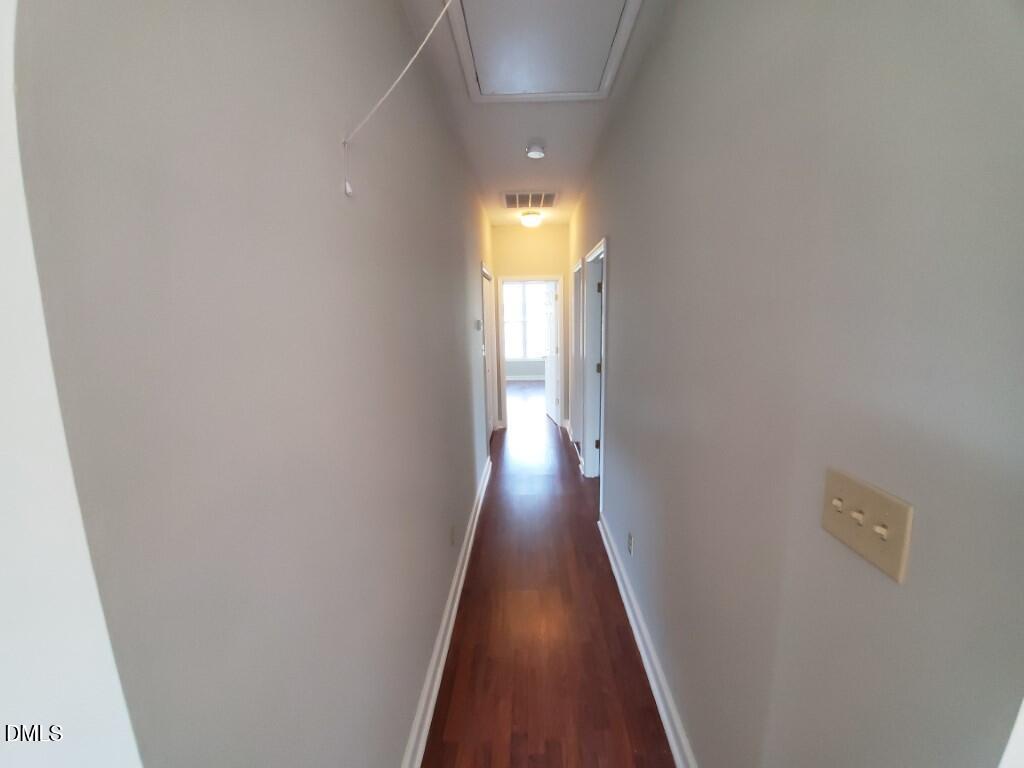 8007 Sundance Circle Durham, NC 27713 - Photo 18 of 23 a view of a hallway with wooden floor and glass door