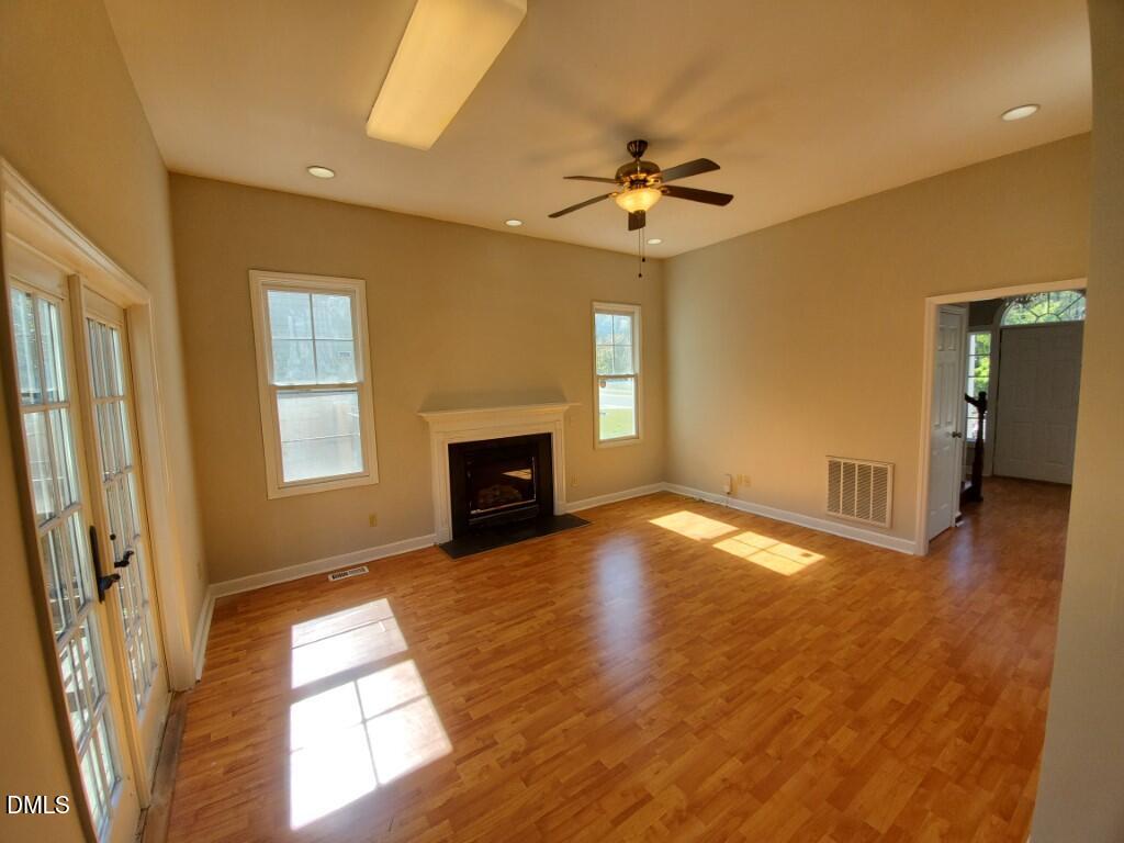 8007 Sundance Circle Durham, NC 27713 - Photo 2 of 23 a view of empty room with wooden floor and fan
