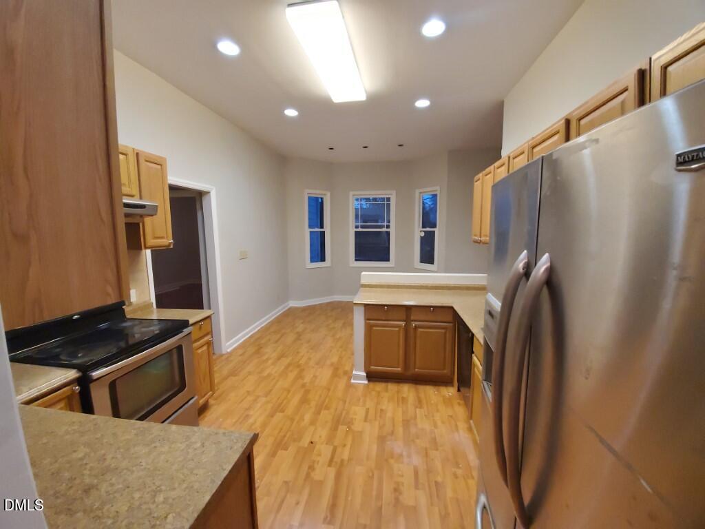 8007 Sundance Circle Durham, NC 27713 - Photo 5 of 23 a kitchen with stainless steel appliances granite countertop a refrigerator a stove and a sink