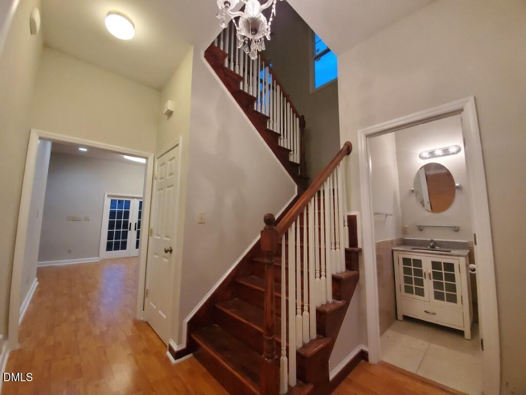 8007 Sundance Circle Durham, NC 27713 - Photo 10 of 23 a view of a hallway with entryway wooden floor and front door