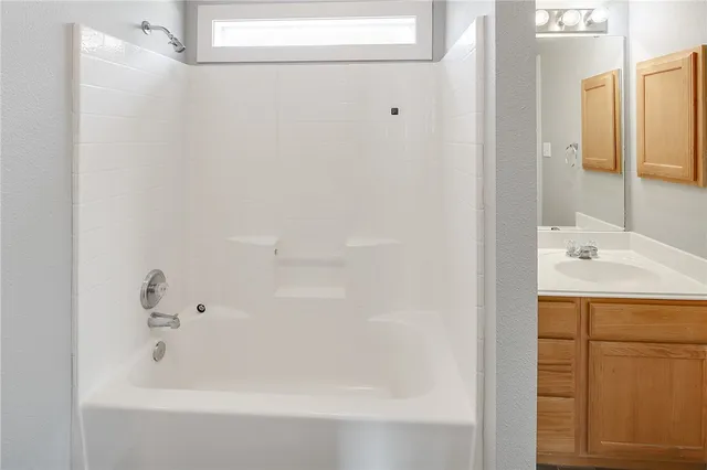 a bathroom with a bathtub and a sink