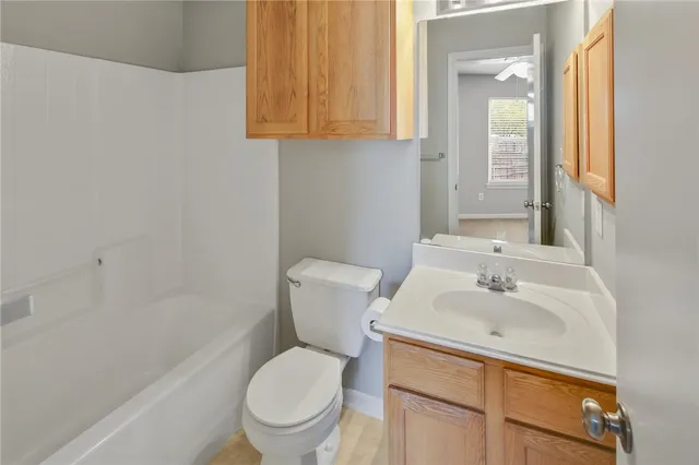 a bathroom with a sink toilet and vanity