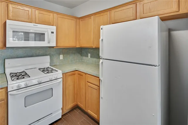 a white refrigerator freezer sitting inside of a kitchen