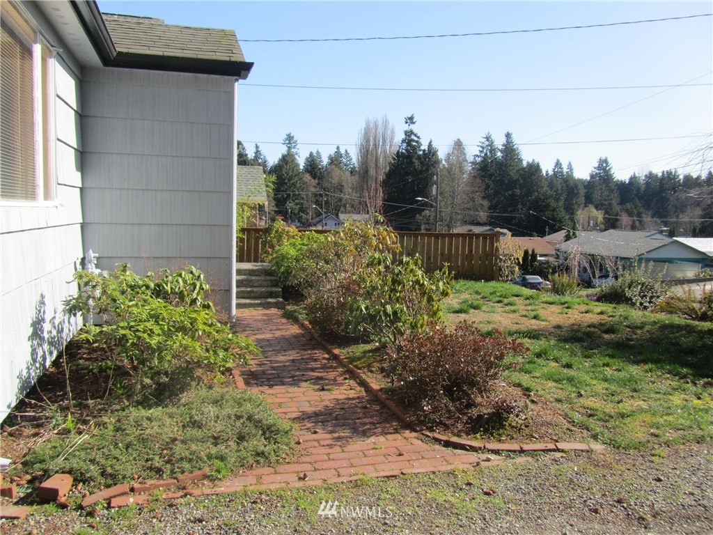 619 Ramsdell Street Fircrest, WA 98466 - Photo 3 of 12 a view of a backyard with pathway
