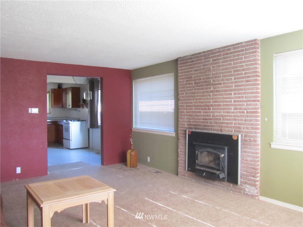 619 Ramsdell Street Fircrest, WA 98466 - Photo 4 of 12 a living room with furniture and a fireplace