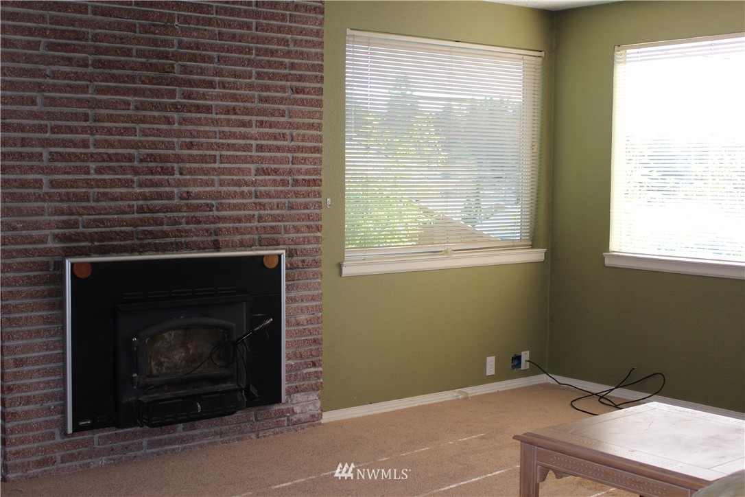 619 Ramsdell Street Fircrest, WA 98466 - Photo 5 of 12 a room with a fireplace