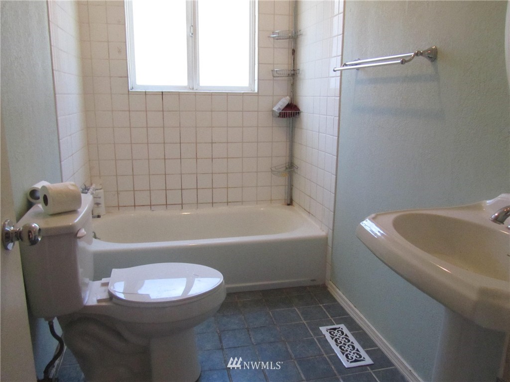619 Ramsdell Street Fircrest, WA 98466 - Photo 8 of 12 a bathroom with a sink a toilet a bathtub and a shower
