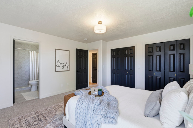 2460 Allison Way Syracuse, UT 84075 - Photo 14 of 24 Carpeted bedroom featuring white walls and black paneled bi-fold closet doors