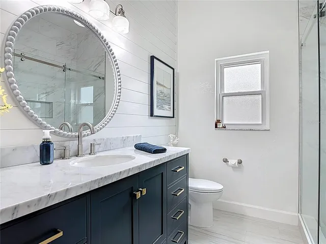 a bathroom with a double vanity sink and a mirror
