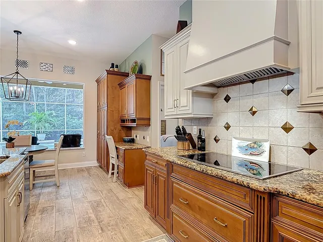 a kitchen with stainless steel appliances granite countertop a sink and cabinets