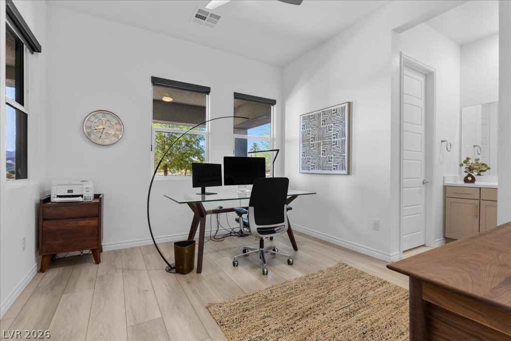20 Charlotte Ridge Place Henderson, NV 89011 - Photo 23 of 33 A well-lit study with ample light, featuring light wood flooring and a versatile layout perfect for a home office.