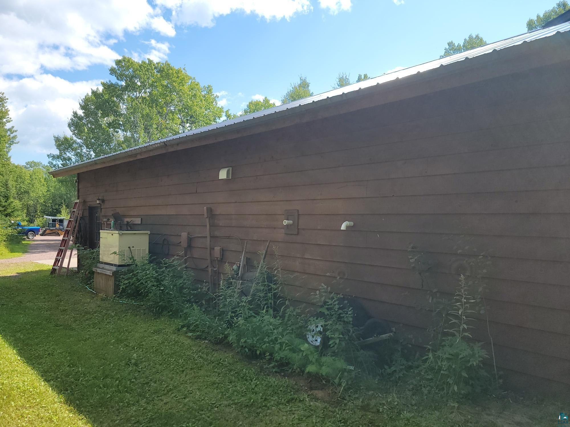 181 Linnell Road Grand Marais, MN 55604 - Photo 12 of 77 Brown horizontal siding with a metal roof