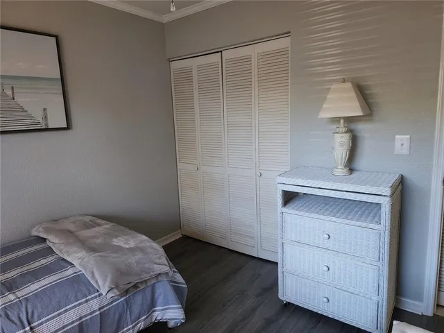 a bedroom with a bed and a lamp on the table