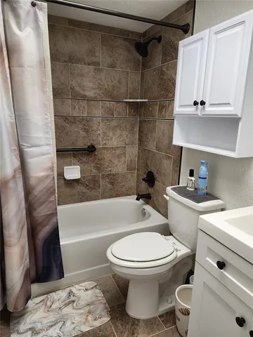 a bathroom with a toilet a sink and bathtub