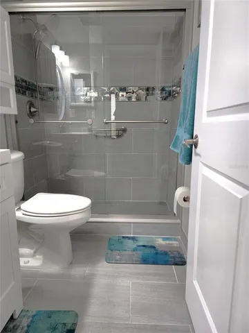 a bathroom with a toilet and a shower