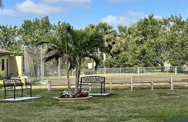a view of a park with table and chairs