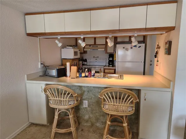 a kitchen with a table and chairs