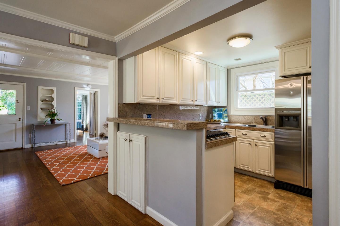 117 Dwight Road Burlingame, CA 94010 - Photo 9 of 20 a kitchen with kitchen island granite countertop a stove refrigerator and sink