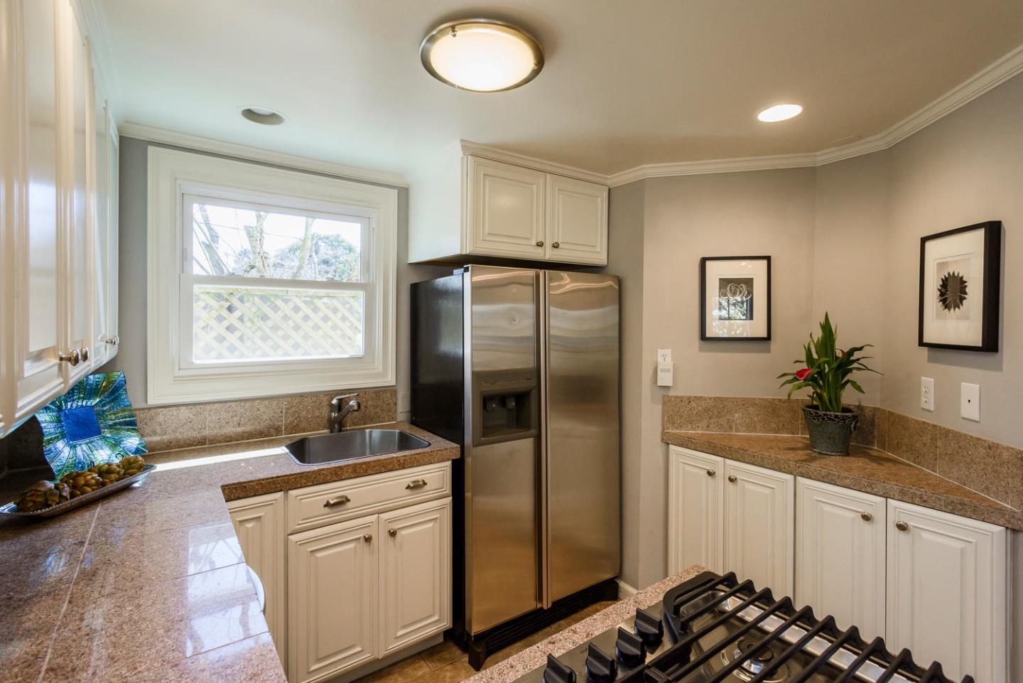 117 Dwight Road Burlingame, CA 94010 - Photo 10 of 20 a kitchen with stainless steel appliances granite countertop a refrigerator and a sink