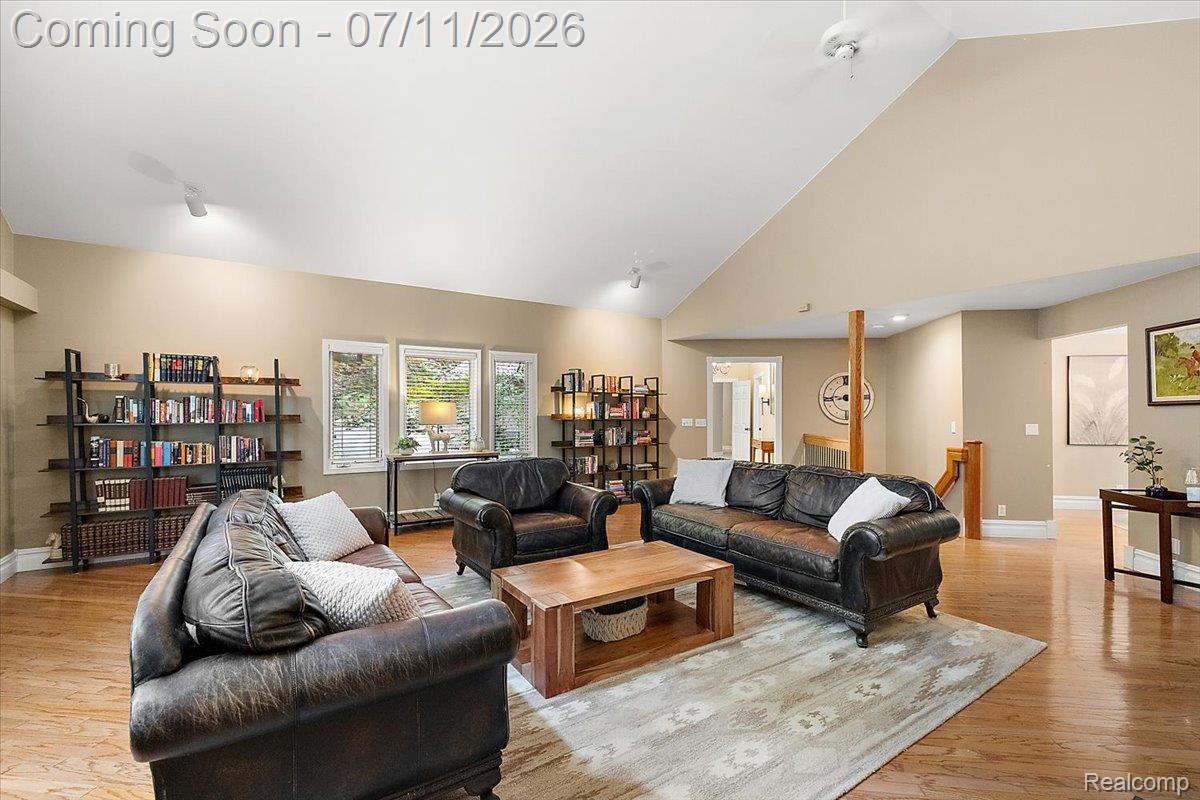 4219 Gardner Road Metamora, MI 48455 - Photo 10 of 87 Spacious living area featuring a vaulted ceiling and hardwood flooring
