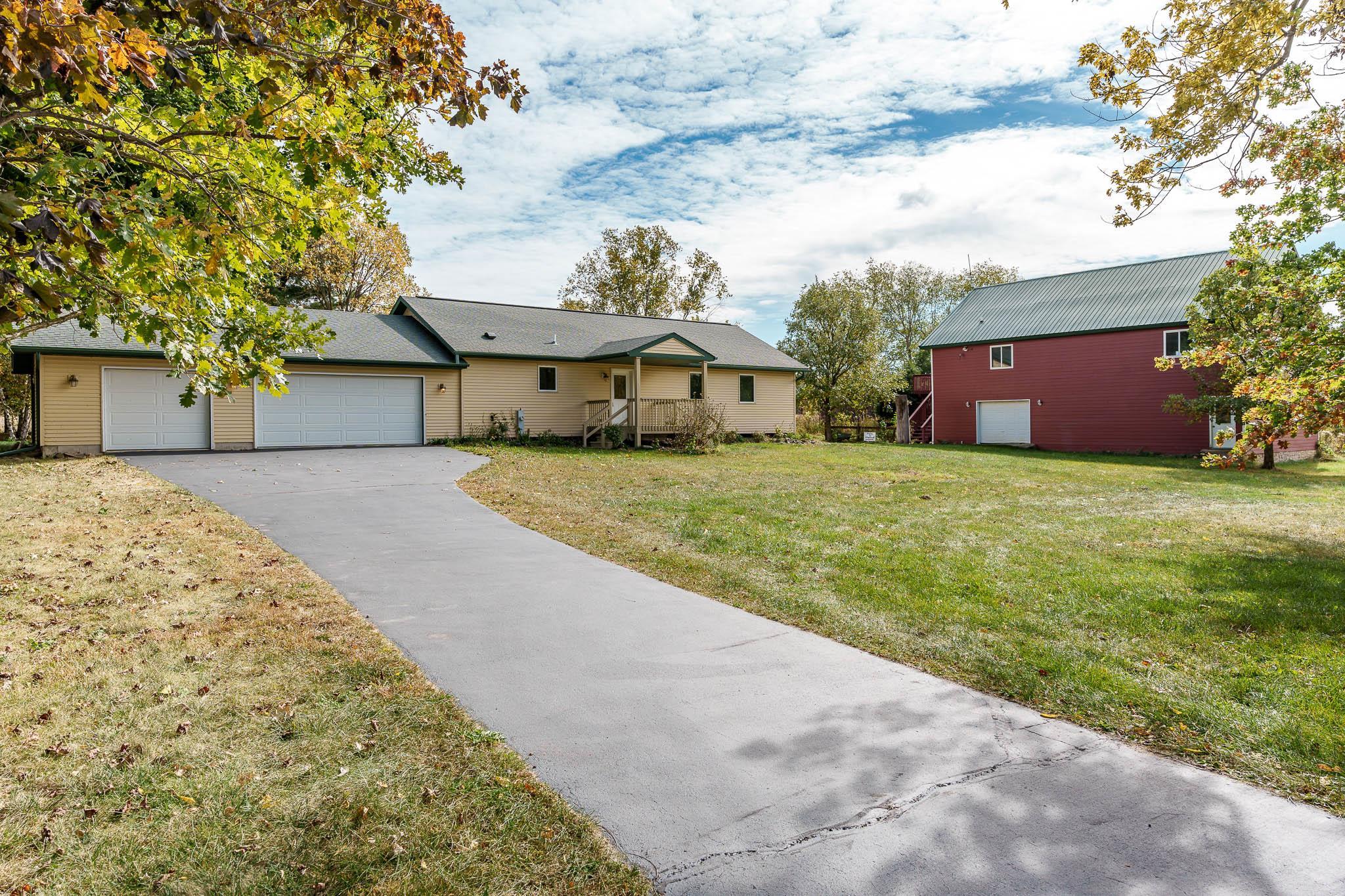 4585 South Chana Road Chana, IL 61015 - Photo 1 of 76 a view of a house with a yard and large tree