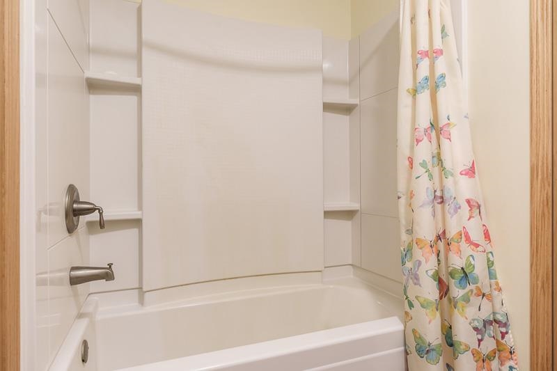 4585 South Chana Road Chana, IL 61015 - Photo 17 of 76 a bathroom with a bathtub and shower