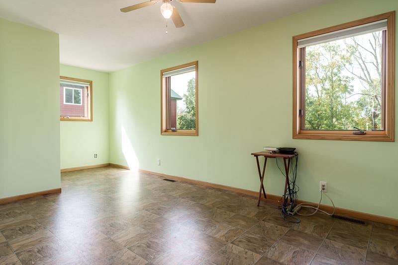 4585 South Chana Road Chana, IL 61015 - Photo 18 of 76 a view of an empty room with a window and wooden floor