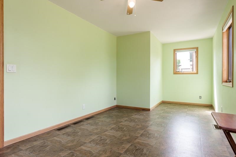 4585 South Chana Road Chana, IL 61015 - Photo 19 of 76 an empty room with wooden floor and windows