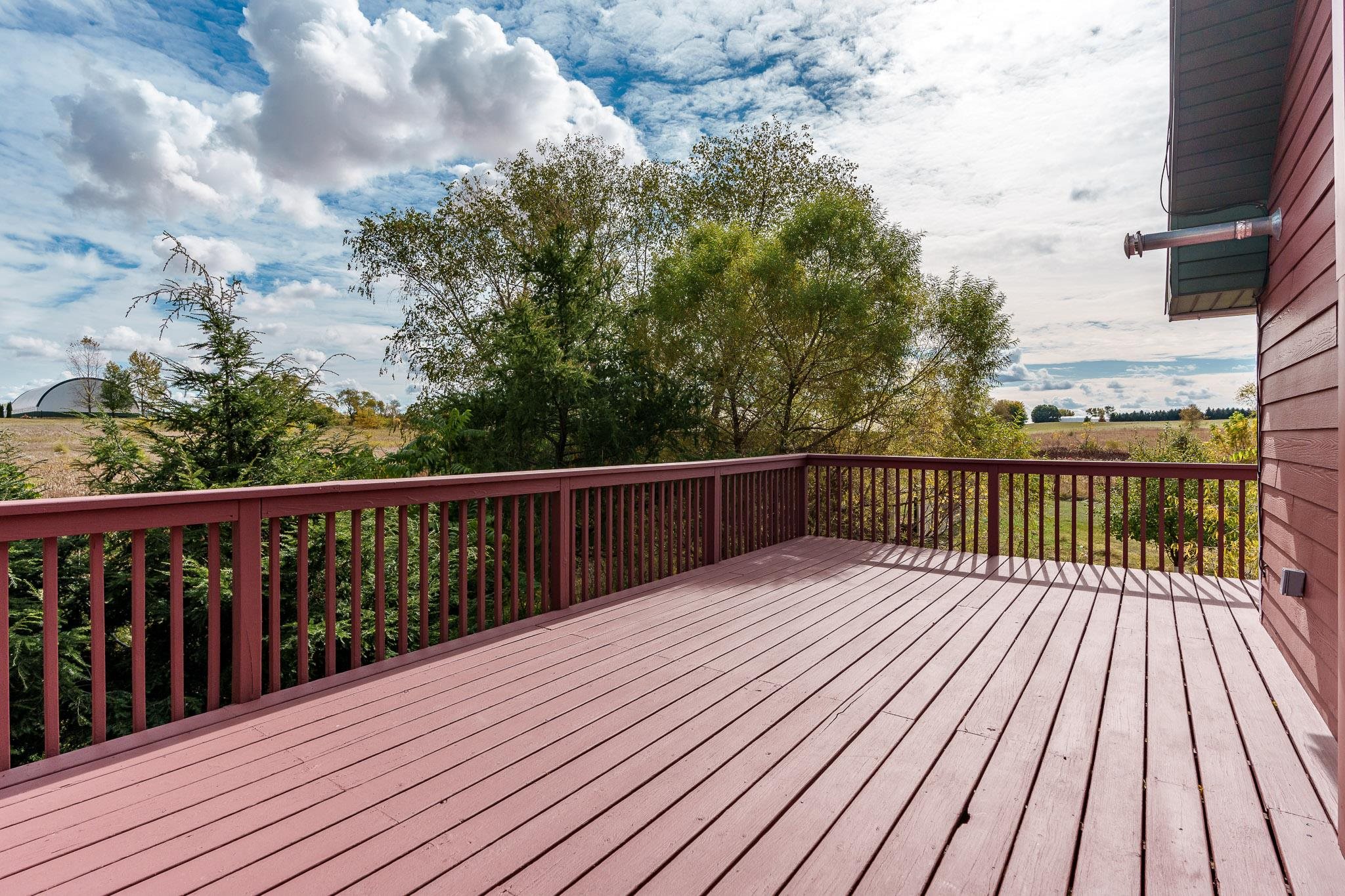 4585 South Chana Road Chana, IL 61015 - Photo 40 of 76 a balcony with wooden floor and trees