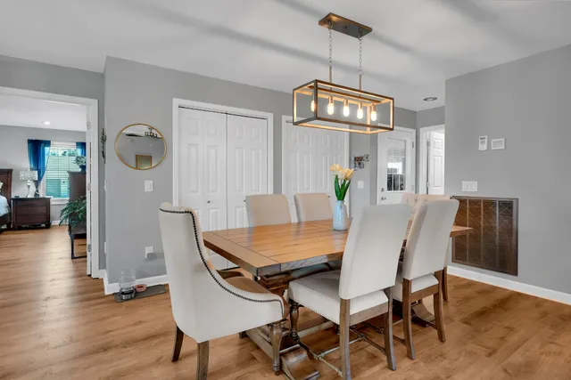 a view of a dining room with furniture wooden floor and chandelier