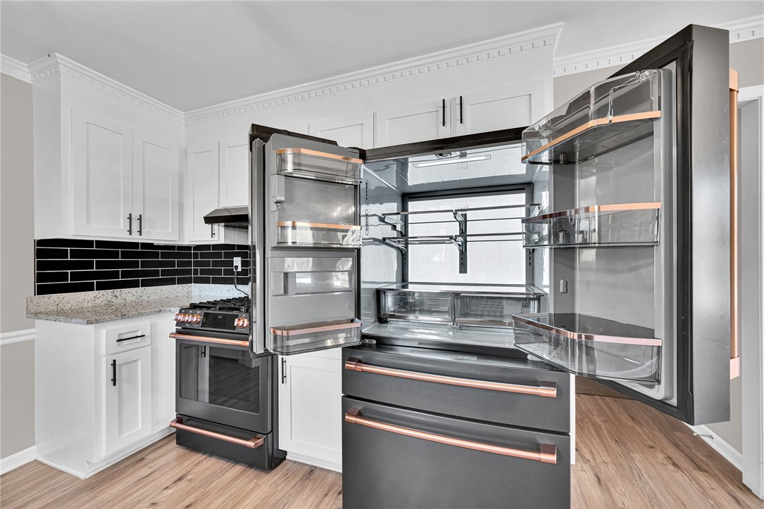 1509 Crestview Road Easley, SC 29642 - Photo 13 of 31 This modern kitchen features a spacious refrigerator and sleek, integrated appliances.