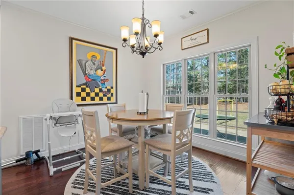 a dining room with furniture a window and a chandelier