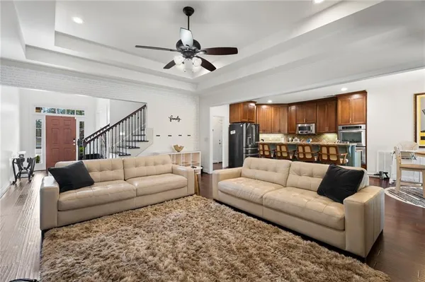 a living room with furniture and a view of kitchen
