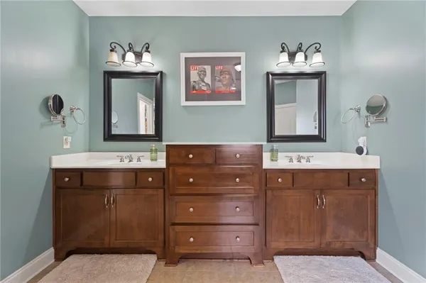 a bathroom with a sink vanity and mirror
