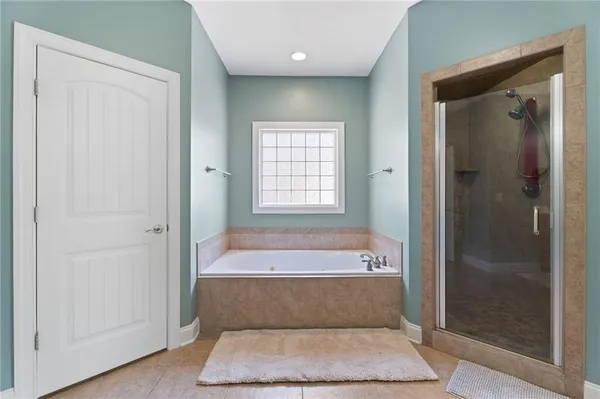 a bathroom with a bathtub and shower