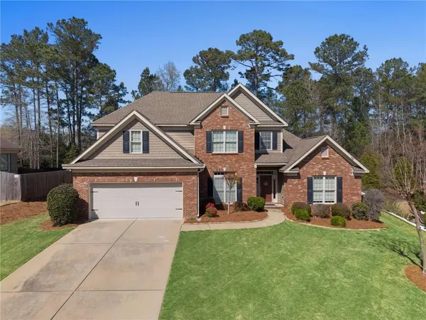 a front view of a house with a yard and garage