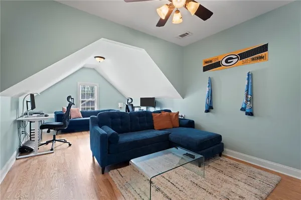 a living room with furniture and wooden floor
