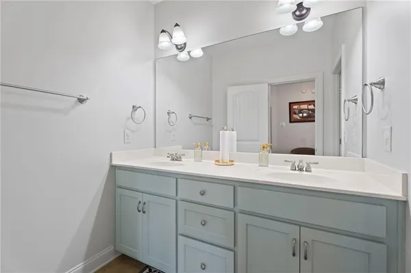 a bathroom with a double vanity sink and a mirror