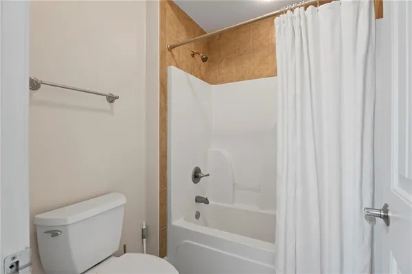a bathroom with a shower and a toilet