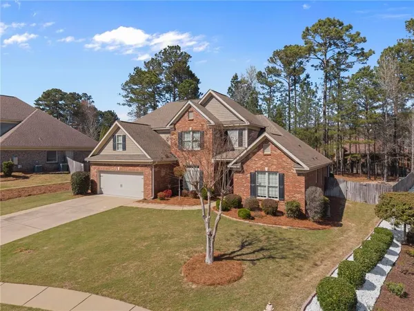 a front view of a house with a yard and garage