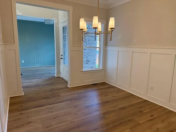 wooden floor in an empty room with a mirror