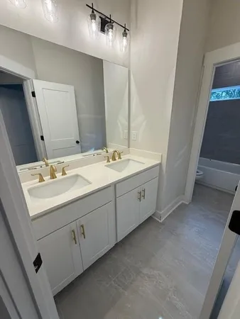 a bathroom with a double vanity sink and mirror