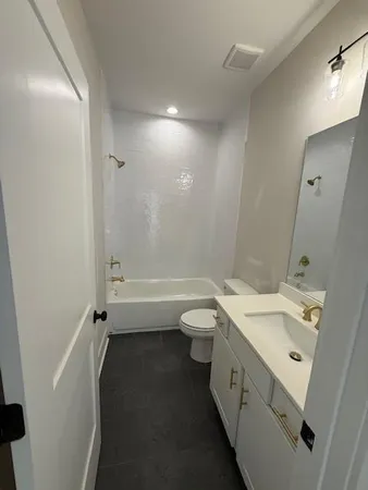 a bathroom with a double vanity sink toilet and shower