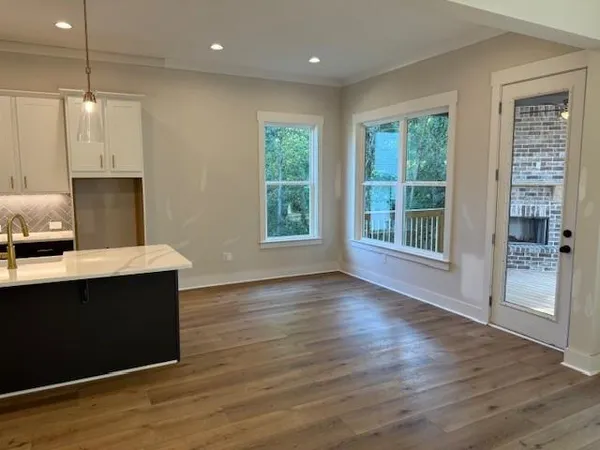 a view of kitchen with wooden floor and window