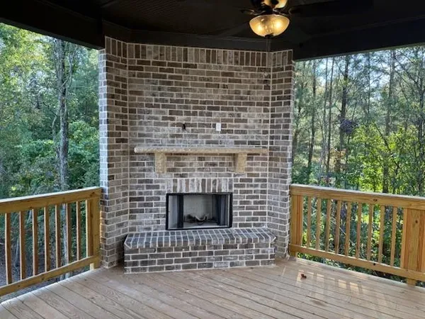 a brick building with a floor to ceiling window and wooden floor